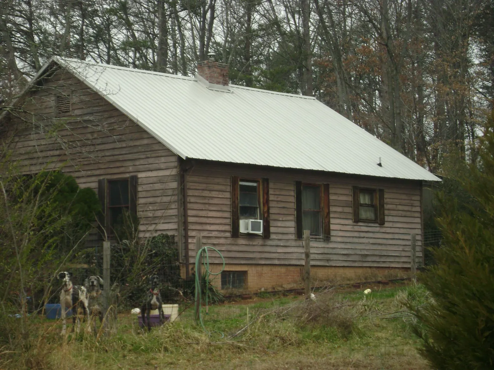 White metal roof on an old wood sided farmhouse, from a Metal Roof Installation job in Walnut Bottom
